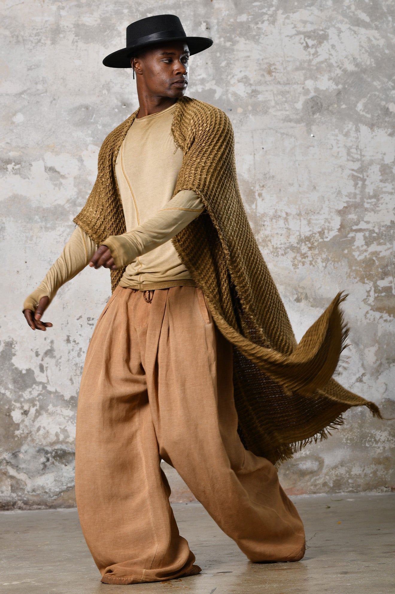 A person wearing the Waffle Poncho, a cozy bohemian-inspired garment made from Turkish cotton, in a serene autumn setting, surrounded by colorful leaves and warm hues, embodying the essence of autumn fashion and comfort.