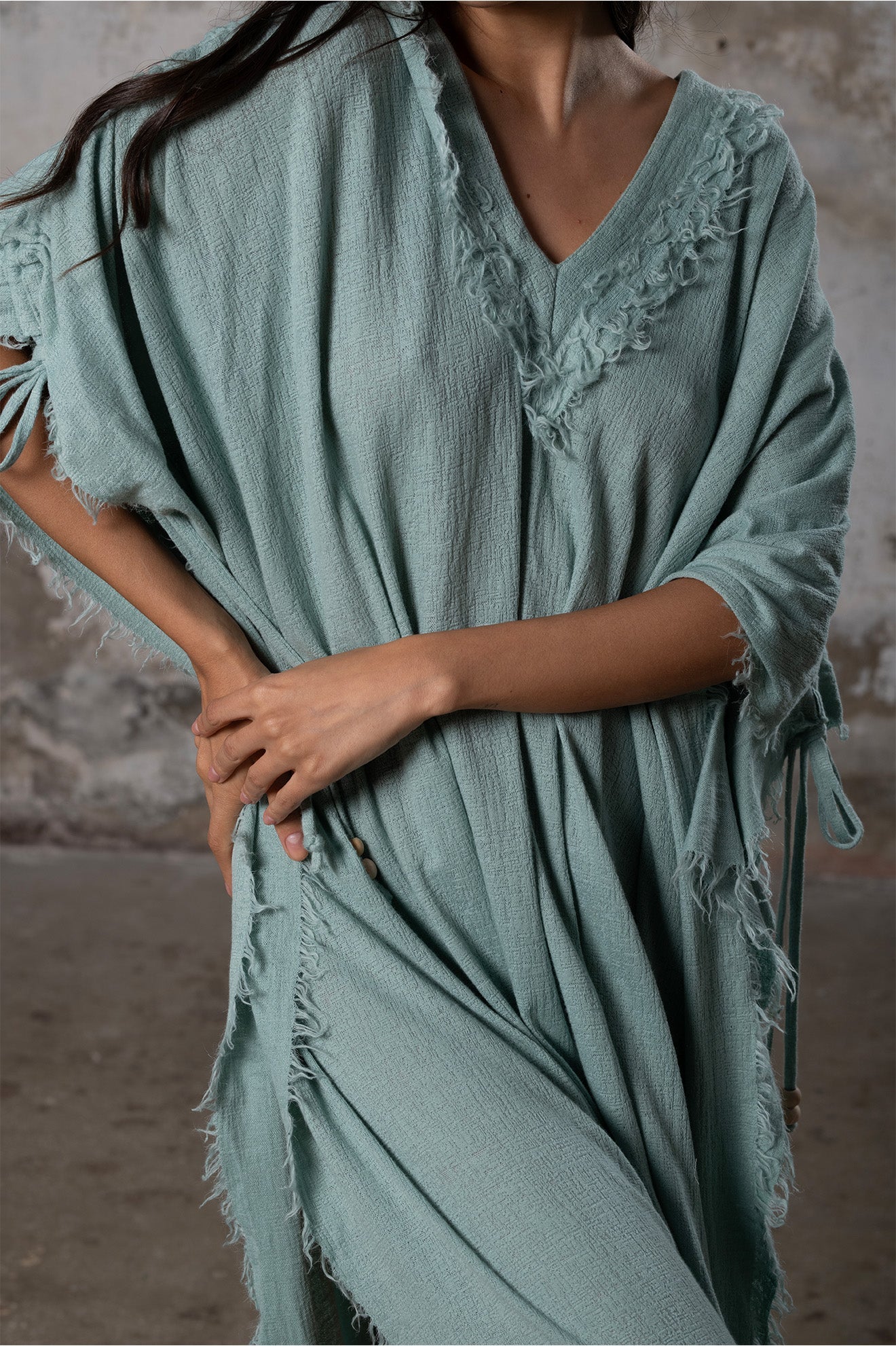 A versatile, earthy goddess dress that embodies boho-chic style. Crafted from the softest cotton fabric, this garment offers both comfort and a fashion statement. The dress can be worn in two distinct styles, either as a kaftan or a sultry dress, with a simple change in the way you put it on. Its natural and ethereal design exudes a warm, comforting feeling against your skin, making it a must-have addition to your wardrobe for those seeking a harmonious blend of style and comfort.