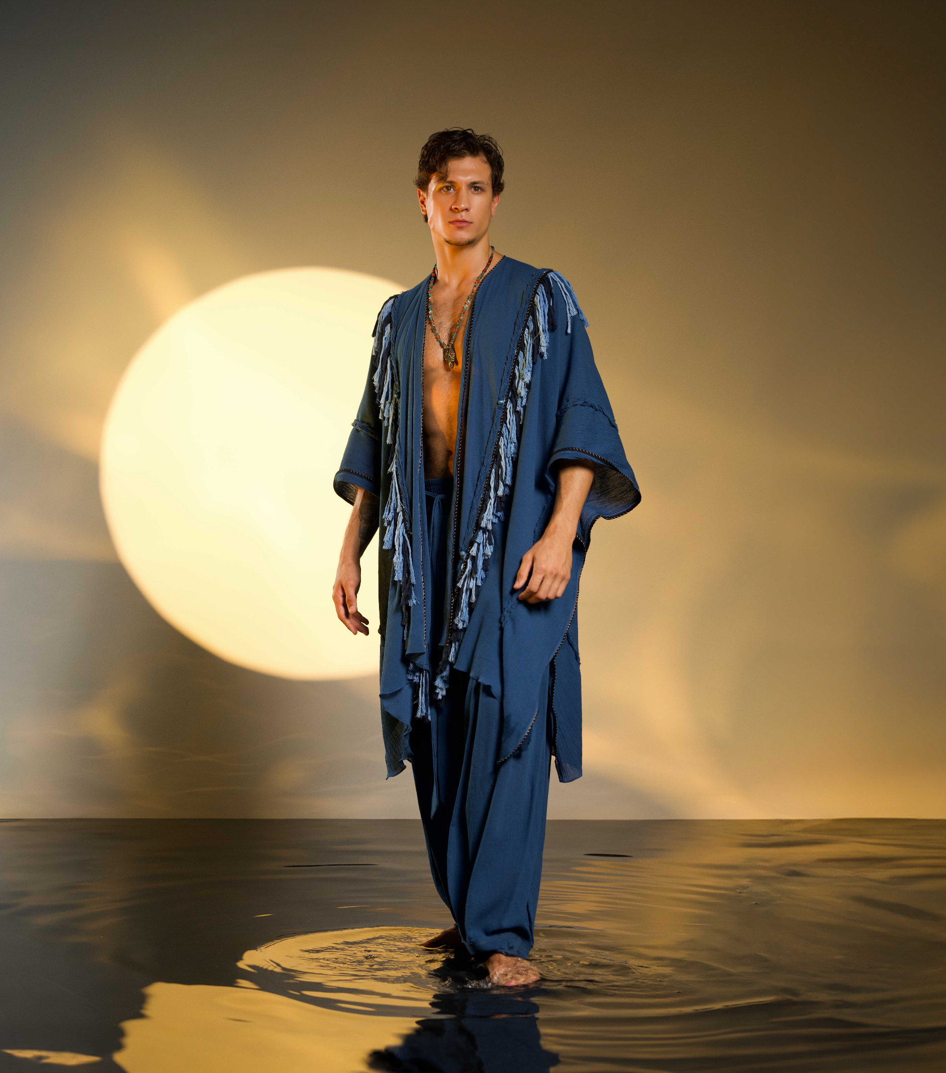 Bohemian poncho for men in navy blue, made from organic cotton with handmade tassels and braided accents, perfect for casual boho or festival fashion.