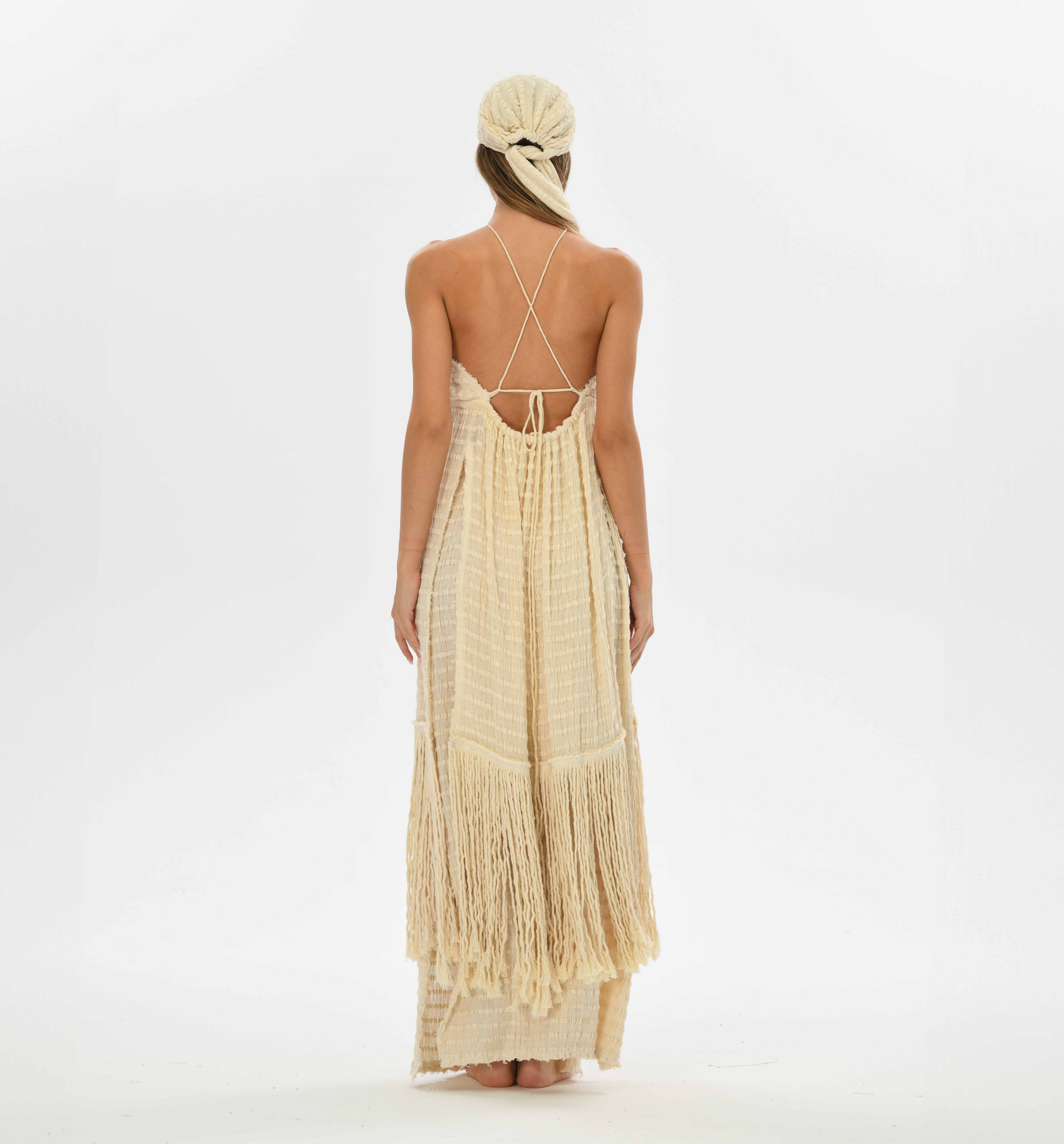 Handwoven cotton fringe top with a tie front and open back, perfect for layering over boho dresses or festival outfits.