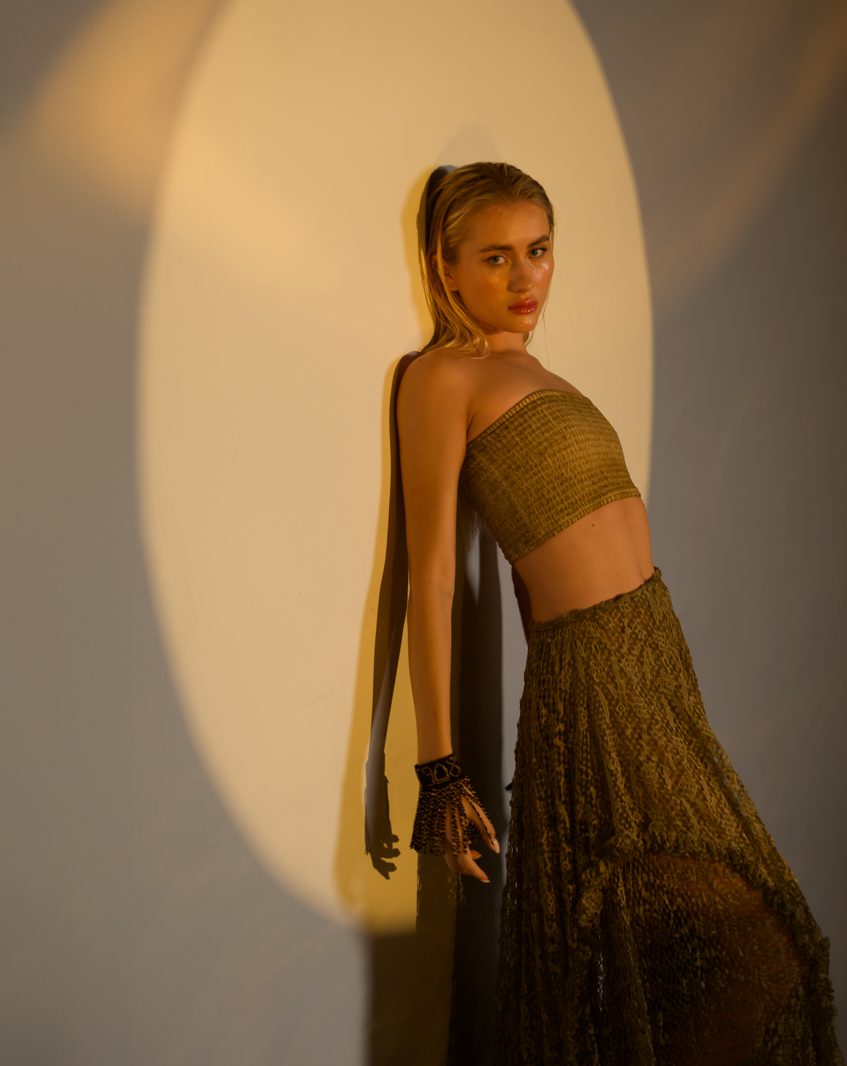 See-through lace skirt in desert sand, designed with a big flowy cut, ideal for layering over shorts, leggings, or wearing as a top.